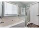 View of bathroom featuring a large tub, separate glass shower, and natural light at 239 Bradford Glyn Dr, Mooresville, NC 28115