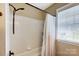 Clean, tiled bathtub/shower with white curtain provides a functional and comfortable bathing space at 239 Bradford Glyn Dr, Mooresville, NC 28115