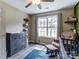 Cozy bedroom with changing table, rocker, area rug, and lots of natural light at 239 Bradford Glyn Dr, Mooresville, NC 28115