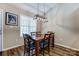 Cozy dining room features a wood table set with modern light fixture and stylish hardwood flooring at 239 Bradford Glyn Dr, Mooresville, NC 28115
