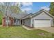 Charming single-Gathering home with brick and vinyl siding, a well-maintained lawn, and an attached two-car garage at 239 Bradford Glyn Dr, Mooresville, NC 28115