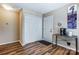Hallway featuring a coat closet, coffee bar table, giraffe art, and wood flooring at 239 Bradford Glyn Dr, Mooresville, NC 28115