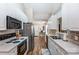 Galley kitchen featuring white cabinets, stainless steel appliances, tile backsplash, and wood flooring at 239 Bradford Glyn Dr, Mooresville, NC 28115