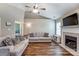 Open living room with a vaulted ceiling, featuring hardwood floors, a fireplace, and views into other living spaces at 239 Bradford Glyn Dr, Mooresville, NC 28115