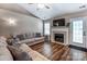 Comfortable living room featuring a fireplace, vaulted ceiling, modern flooring, and a cozy seating arrangement at 239 Bradford Glyn Dr, Mooresville, NC 28115