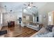 Spacious open-concept living area with hardwood floors, a fireplace, and seamless transition to the kitchen and dining at 239 Bradford Glyn Dr, Mooresville, NC 28115