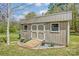 Backyard storage shed with wooden ramp and well-maintained landscape design, offering both utility and aesthetic appeal at 239 Bradford Glyn Dr, Mooresville, NC 28115