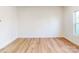 Cozy bedroom with hardwood flooring, neutral walls, and a window providing natural light at 2792 Yeager Nw Dr, Concord, NC 28027