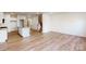 Spacious open-concept living area with hardwood floors connecting the kitchen and staircase at 2792 Yeager Nw Dr, Concord, NC 28027
