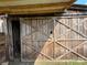 Large, decorative wooden barn door with crossbeam design, partially open to the interior at 291 Love Valley Rd, Statesville, NC 28625