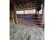 Indoor barn pen with hay and red metal gate at 291 Love Valley Rd, Statesville, NC 28625