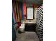 Colorful bathroom featuring vibrant wall stripes, a unique toilet, and dark vanity at 291 Love Valley Rd, Statesville, NC 28625