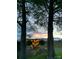 Beautiful sunset view from a tree-lined yard with colorful stained glass art at 291 Love Valley Rd, Statesville, NC 28625