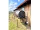 Exterior showcasing a dark colored compost tumbler set near a wooden structure with a window at 291 Love Valley Rd, Statesville, NC 28625