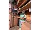 Rustic wooden interior featuring a wall-mounted TV, shelving with jars, and a fold down table at 291 Love Valley Rd, Statesville, NC 28625