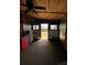 Rustic interior with wood paneling, featuring a carpeted floor and natural light coming through windows and open doorway at 291 Love Valley Rd, Statesville, NC 28625