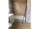 Bathroom showcasing a tiled shower-tub and a white vanity with a mirror and chrome fixtures at 401 Plymouth St, Kannapolis, NC 28083