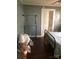 Bedroom featuring a metal bed frame, dark wood flooring, and doorway to the bathroom at 401 Plymouth St, Kannapolis, NC 28083