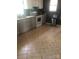 Kitchen with modern appliances, grey cabinets, tile backsplash, and durable tile flooring at 401 Plymouth St, Kannapolis, NC 28083