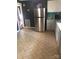 Kitchen featuring stainless steel refrigerator, tile backsplash, grey cabinets, and durable tile flooring at 401 Plymouth St, Kannapolis, NC 28083