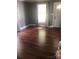 Living room featuring hardwood floors, neutral paint, and abundant natural light at 401 Plymouth St, Kannapolis, NC 28083