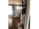 Living room with hardwood floors, neutral paint, and front door visible in the background at 401 Plymouth St, Kannapolis, NC 28083