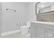 Well-lit bathroom featuring a gray vanity, tile flooring, and a decorative penny tile backsplash at 403 Greenbriar S Rd, Statesville, NC 28625