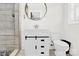 Bright bathroom with a stylish vanity, round mirror, and tiled shower at 403 Greenbriar S Rd, Statesville, NC 28625