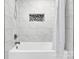 Bright bathroom showcasing a tub with white marble-style tile and an elegant shower curtain at 403 Greenbriar S Rd, Statesville, NC 28625
