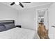 Cozy bedroom with neutral walls, a ceiling fan, and a view into an adjacent dining area at 403 Greenbriar S Rd, Statesville, NC 28625