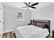 Comfortable bedroom with wood-look floors, a ceiling fan, and a window for natural light at 403 Greenbriar S Rd, Statesville, NC 28625
