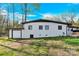 Exterior shot of a white brick home with a one-car garage and a well-manicured lawn at 403 Greenbriar S Rd, Statesville, NC 28625