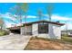 Inviting single-story home with a large carport, modern windows, and lush landscaping at 403 Greenbriar S Rd, Statesville, NC 28625