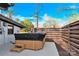 Backyard patio features a wooden hot tub with a black cover and a contemporary privacy fence at 403 Greenbriar S Rd, Statesville, NC 28625