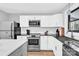 Well-equipped kitchen with stainless steel appliances, white cabinetry, and functional layout at 403 Greenbriar S Rd, Statesville, NC 28625