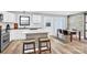 Open kitchen area with a central island, bar seating, and modern appliances leading to the dining area at 403 Greenbriar S Rd, Statesville, NC 28625
