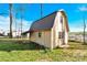 Exterior shot of an outbuilding with a metal roof, sitting on a grass lot with mature trees at 403 Greenbriar S Rd, Statesville, NC 28625