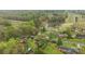 Aerial view captures a home nestled among mature trees, featuring a tranquil pond and lush green spaces at 405 Downing Dr, Kings Mountain, NC 28086