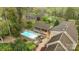 Aerial view showcasing the house's backyard featuring a private pool, screened-in porch, and patio area at 405 Downing Dr, Kings Mountain, NC 28086