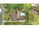 An aerial top-down view of a house with a swimming pool, patio, driveway, and surrounding greenery at 405 Downing Dr, Kings Mountain, NC 28086