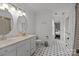Bathroom featuring a double vanity, toilet, tub, and unique patterned flooring at 405 Downing Dr, Kings Mountain, NC 28086