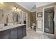 Neutral-toned bathroom with double sink vanity, toilet, and glass-enclosed shower at 405 Downing Dr, Kings Mountain, NC 28086