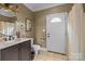 Bathroom featuring a sink, toilet, shower, and exterior door at 405 Downing Dr, Kings Mountain, NC 28086