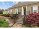 Home's front entrance with brick stairs, beautiful landscaping, and dark shutters provide curb appeal at 405 Downing Dr, Kings Mountain, NC 28086