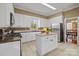 Updated kitchen featuring white cabinets, stainless appliances and a granite island at 405 Downing Dr, Kings Mountain, NC 28086