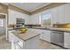 Bright kitchen features white cabinetry, stainless appliances, and center island at 405 Downing Dr, Kings Mountain, NC 28086
