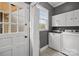 Updated laundry room includes white cabinets, and a view to the exterior at 405 Downing Dr, Kings Mountain, NC 28086