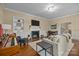 Bright living room featuring a fireplace, hardwood floors, comfortable seating, and a piano at 405 Downing Dr, Kings Mountain, NC 28086
