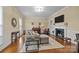 Cozy living room featuring a fireplace, hardwood floors, piano, and comfortable seating at 405 Downing Dr, Kings Mountain, NC 28086