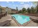 Enjoy this backyard pool with a stone surround, iron fencing, and green grass, perfect for relaxing at 405 Downing Dr, Kings Mountain, NC 28086